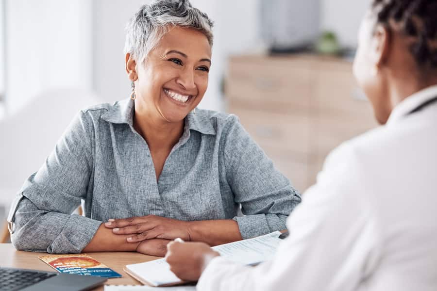 A woman speaking with a healthcare professional during a private consultation